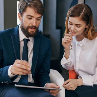 colleagues-communicate-with-tablet-technology-office